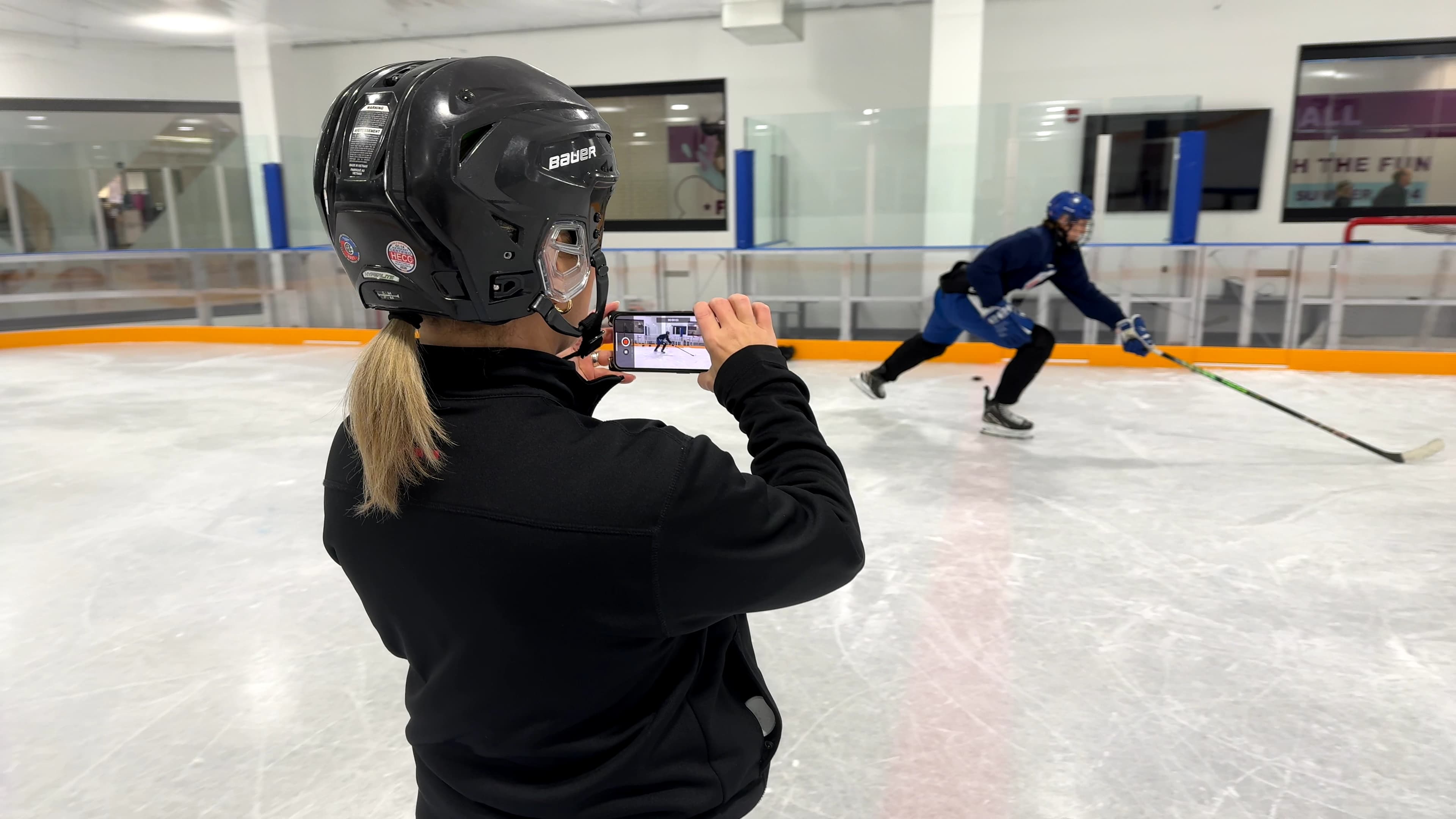 Coach filming athlete during analysis session